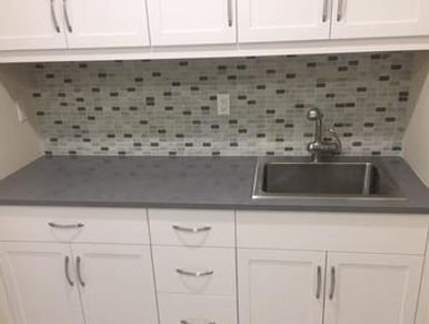 Modern kitchen sink with tiled backsplash