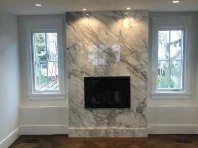 Marble fireplace between two windows