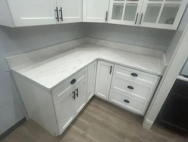 Corner kitchen with white cabinetry