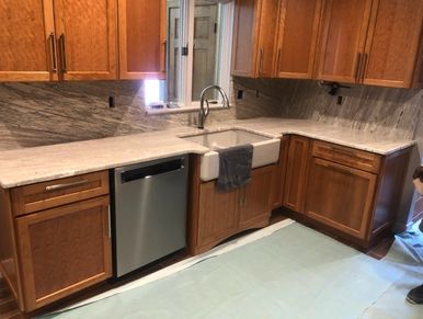 Stainless steel dishwasher in wooden kitchen
