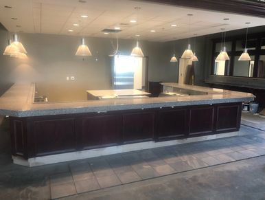 Empty bar area with wooden counter