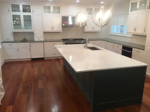 Elegant kitchen with globe lights and island.